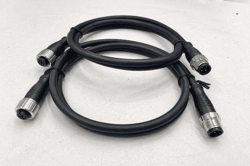 M12 D-coded male and female connectors with a four-contact mating face