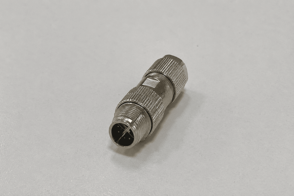 Exploded M12 X-coded assembly showing contacts divider shield and cable pairs