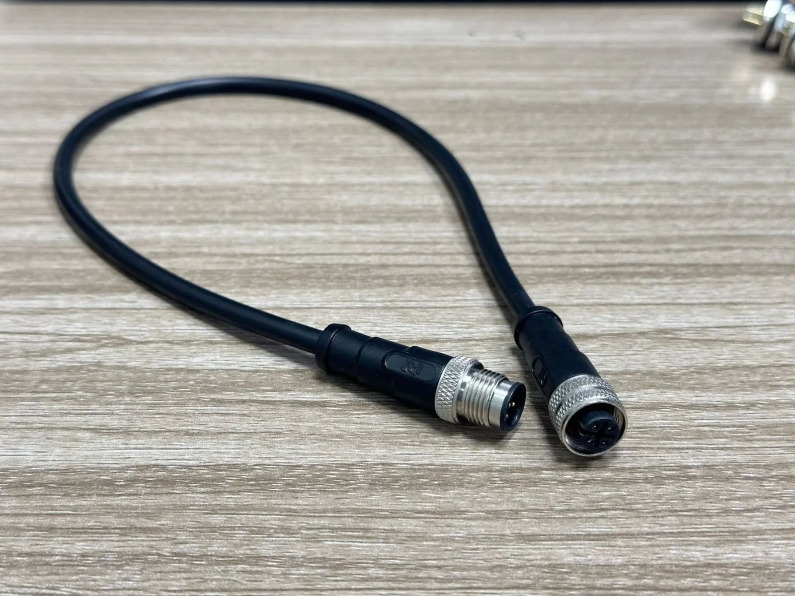 Common wire colors in an M12 4-pin sensor cable Brown white blue and black conductors terminated to an M12 A-coded connector